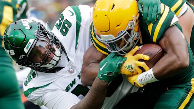Jets' DT Quinnen Williams stop Packers' RB Aaron Jones in a 2022 game at Lambeau Field